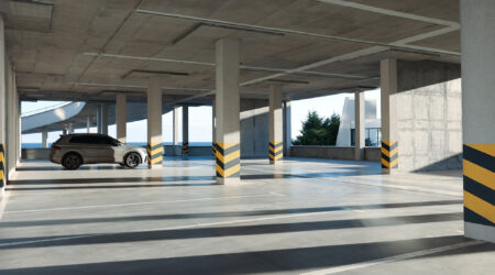 Open parking garage with car on sunny day