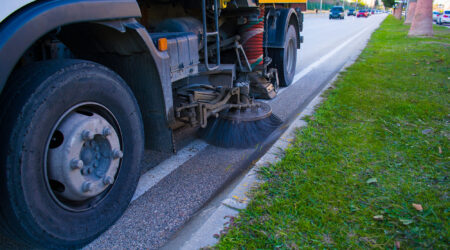 Side view of a street sweeper machine car cleaning the road