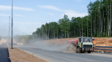 Truck on the road kicking up dust Truck on the road kicking up dust