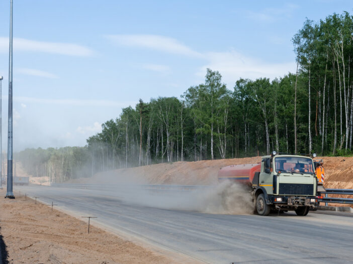 Truck on the road kicking up dust